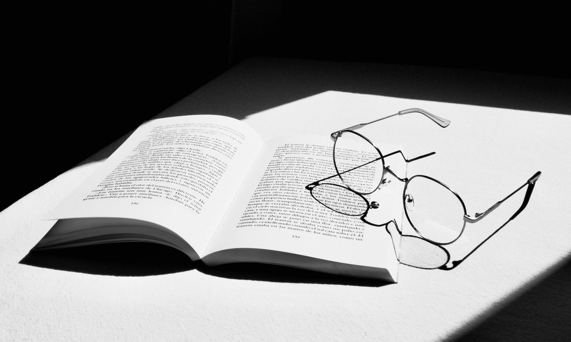 glasses on top of an open book
